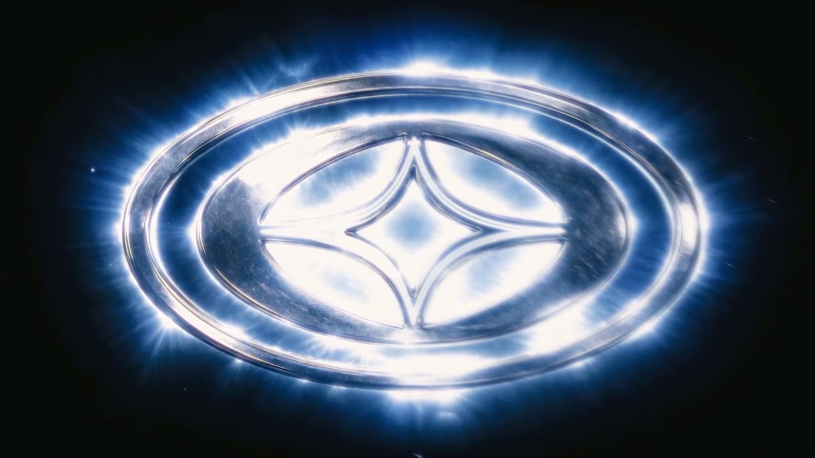 Lowlight Studio emblem — a metallic four-point star medallion glowing in white light on a black background